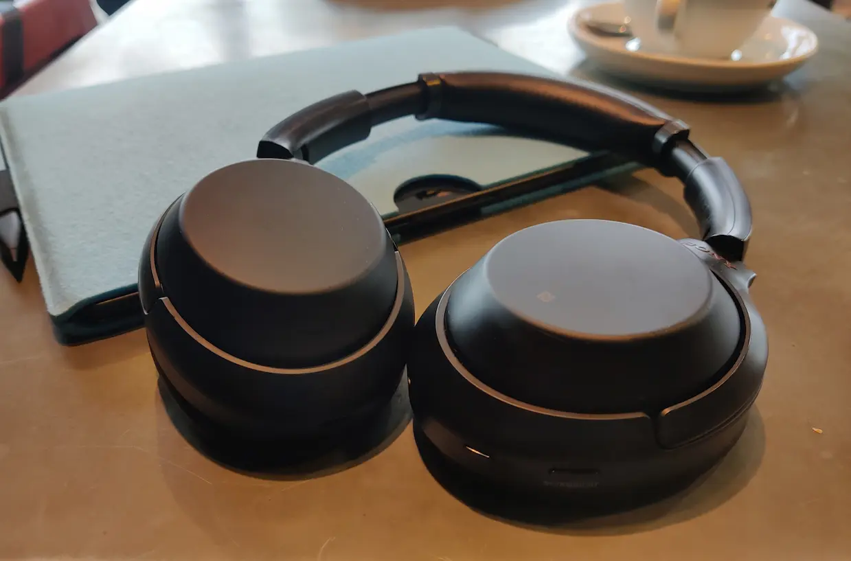 sony headphones on table with coffee cup in background